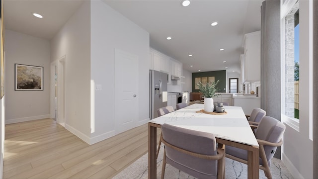 dining space featuring baseboards, recessed lighting, and light wood-style flooring