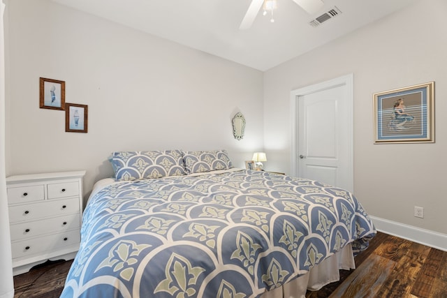 bedroom featuring a ceiling fan, baseboards, visible vents, and wood finished floors