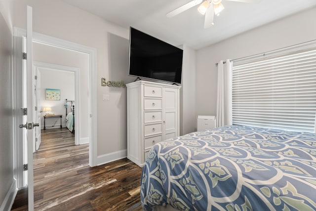 bedroom featuring dark wood-style flooring, baseboards, and a ceiling fan