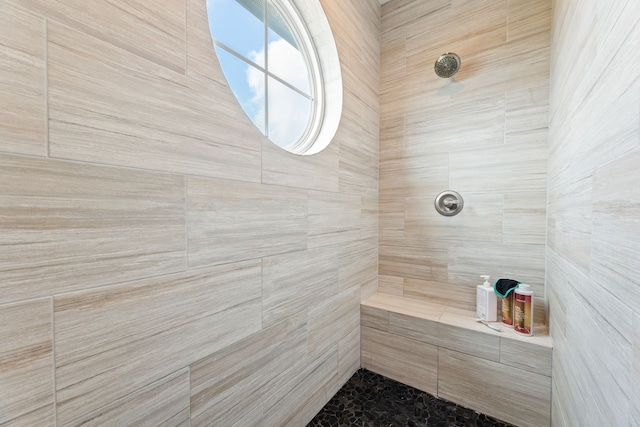 bathroom with tiled shower
