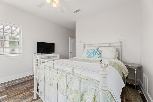 bedroom with visible vents, baseboards, ceiling fan, and wood finished floors