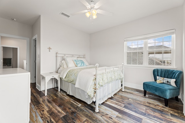 bedroom with visible vents, dark wood finished floors, ceiling fan, and baseboards