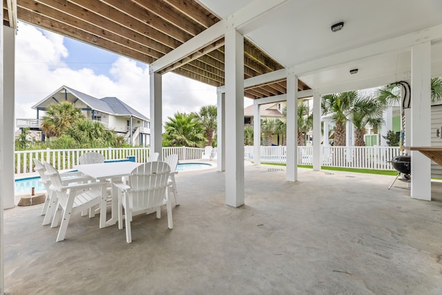 view of patio / terrace with a fenced in pool, outdoor dining area, and fence