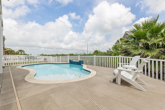 view of pool with a fenced in pool, fence, and a patio area