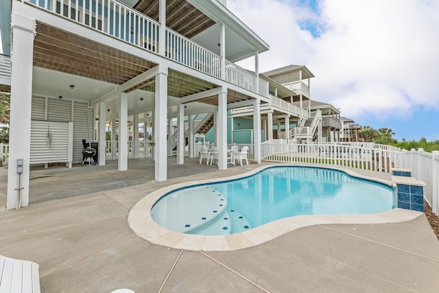 view of swimming pool featuring a patio, fence, stairs, and a fenced in pool