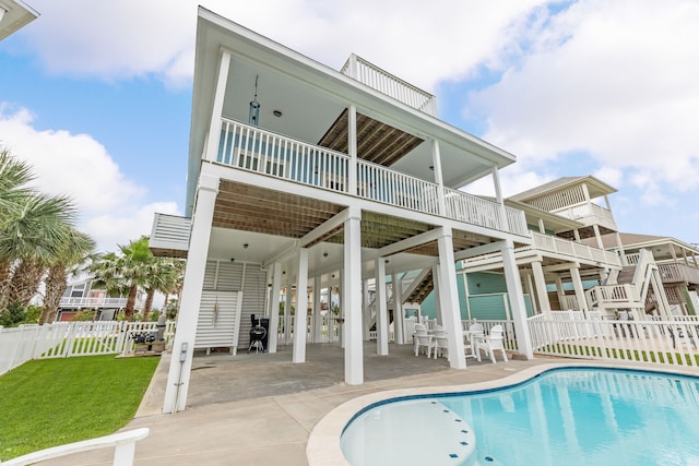 rear view of property featuring fence, a fenced in pool, stairs, and a patio area