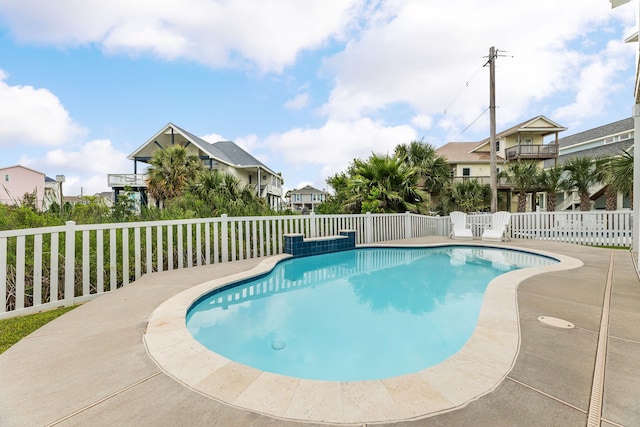 view of pool with a fenced in pool, fence, and a residential view