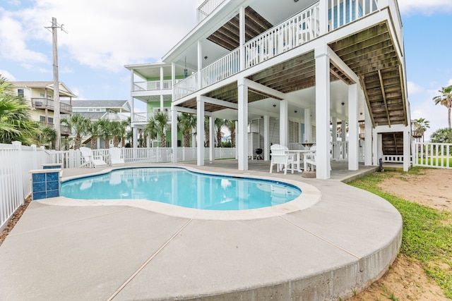 view of swimming pool with a patio, fence, and a fenced in pool