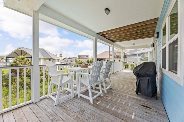 deck with area for grilling, a residential view, and outdoor dining area