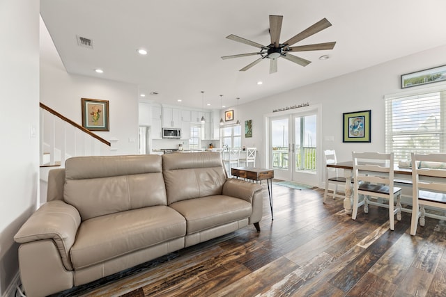 living room featuring visible vents, ceiling fan, stairway, dark wood-type flooring, and recessed lighting