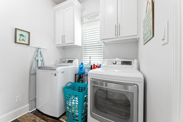 laundry area with baseboards, cabinet space, dark wood-style floors, and washing machine and clothes dryer
