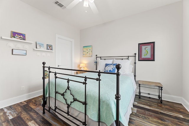 bedroom featuring baseboards, ceiling fan, wood finished floors, and visible vents