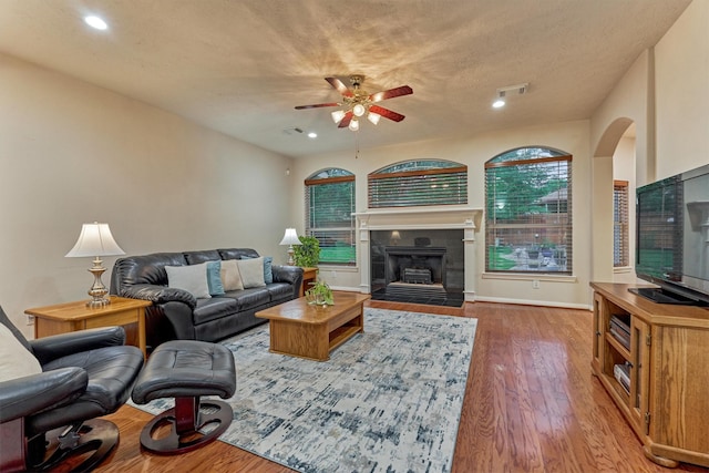 living room featuring a ceiling fan, wood finished floors, recessed lighting, a tile fireplace, and baseboards