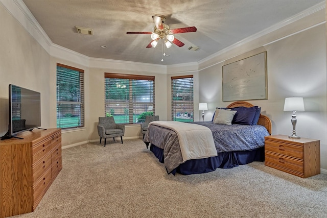 carpeted bedroom featuring crown molding, baseboards, and ceiling fan