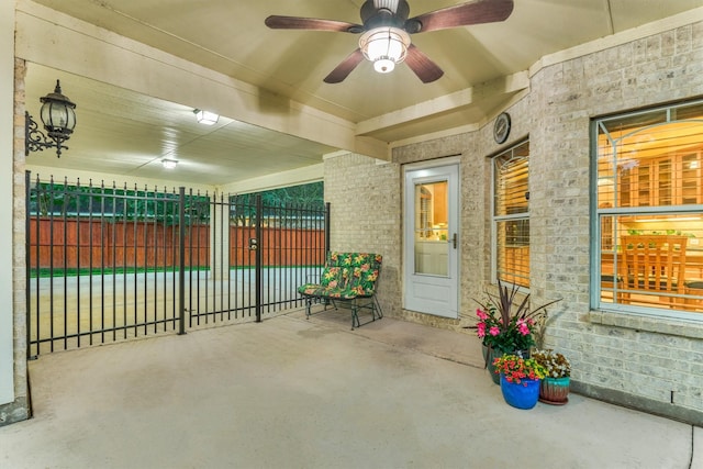view of patio / terrace with fence and a ceiling fan