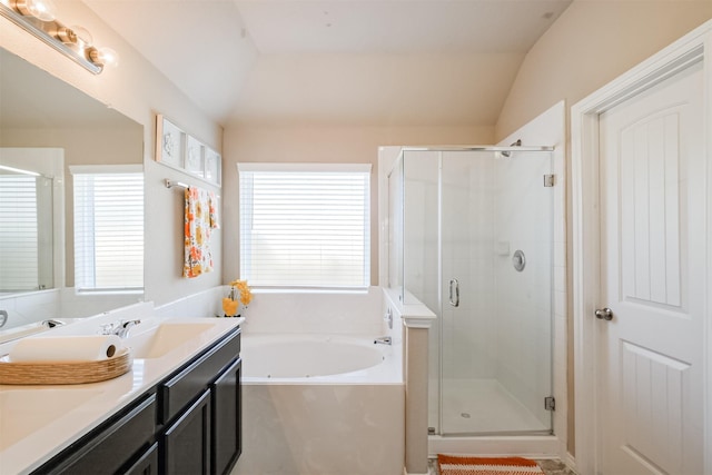 bathroom featuring a garden tub, a sink, a stall shower, and vaulted ceiling