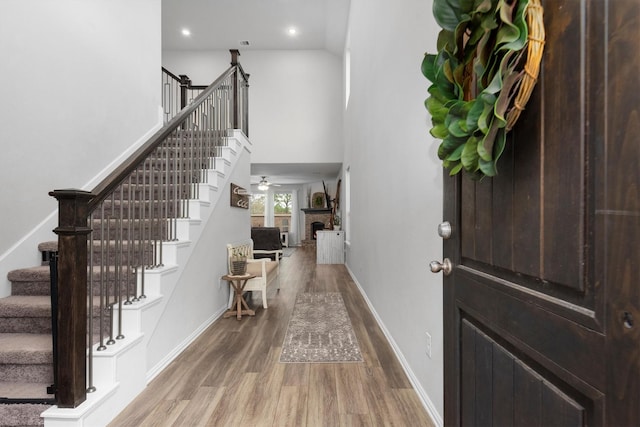 15502 Bosque Valley Ct, Cypress, TX 77433 - entryway with baseboards, stairs, wood finished floors, and a fireplace