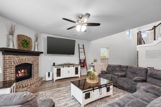 15502 Bosque Valley Ct, Cypress, TX 77433 - living room with baseboards, a ceiling fan, a brick fireplace, and wood finished floors