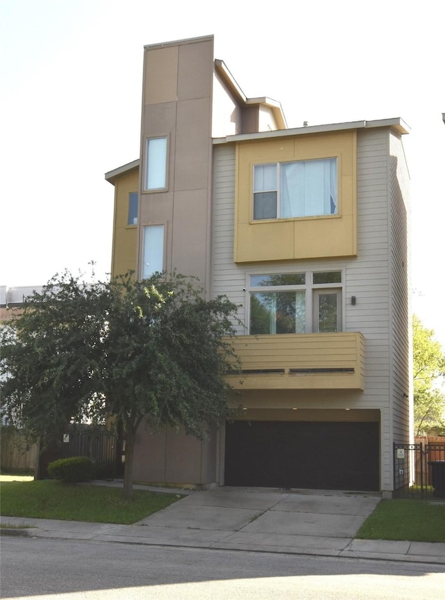3804 Lovejoy St, Houston, TX 77003 - modern home featuring a garage, fence, and concrete driveway
