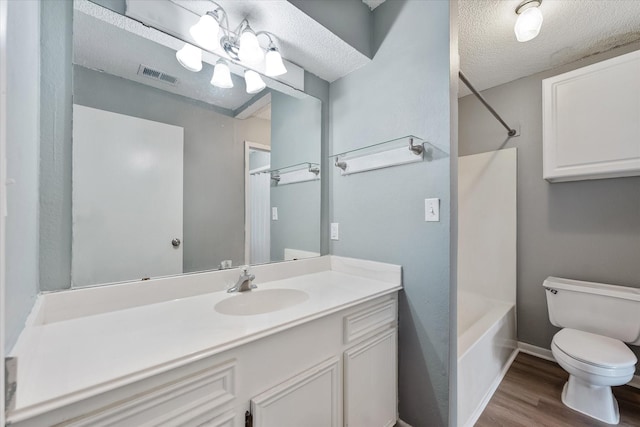 1094 Redfish St, Hitchcock, TX 77563 - bathroom with toilet, a textured ceiling, wood finished floors,  shower combination, and visible vents