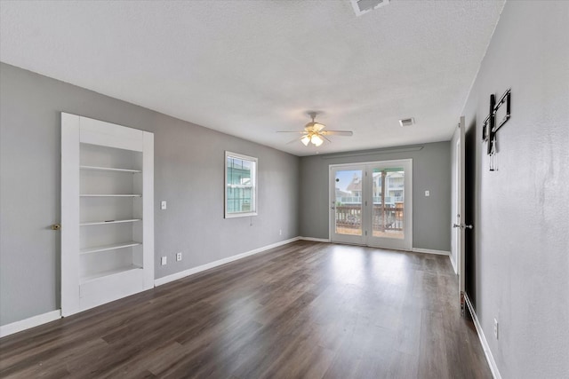 1094 Redfish St, Hitchcock, TX 77563 - unfurnished room with dark wood-type flooring, a ceiling fan, baseboards, and visible vents