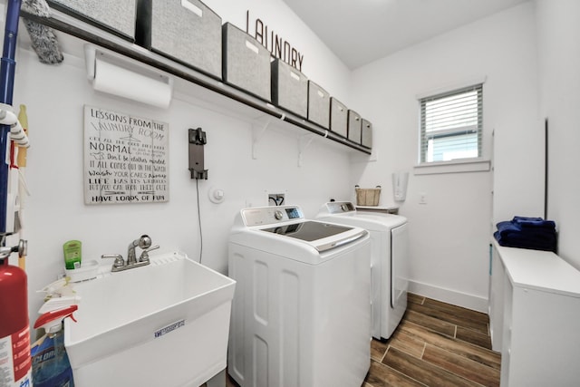 laundry room featuring washer and dryer, wood finish floors, and baseboards