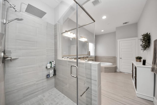 full bath featuring a shower stall, a bath, and recessed lighting