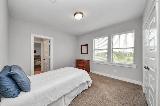 bedroom with carpet and baseboards