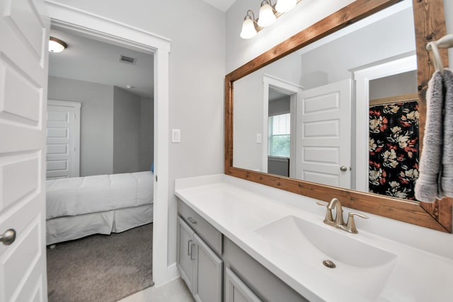 bathroom featuring vanity and a walk in closet