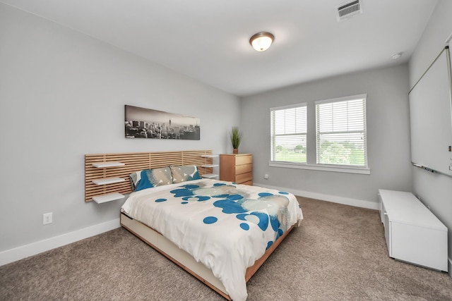 carpeted bedroom featuring baseboards