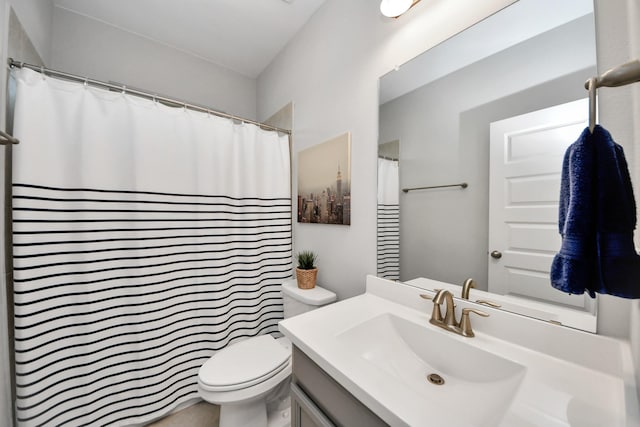 bathroom with toilet, vanity, and curtained shower