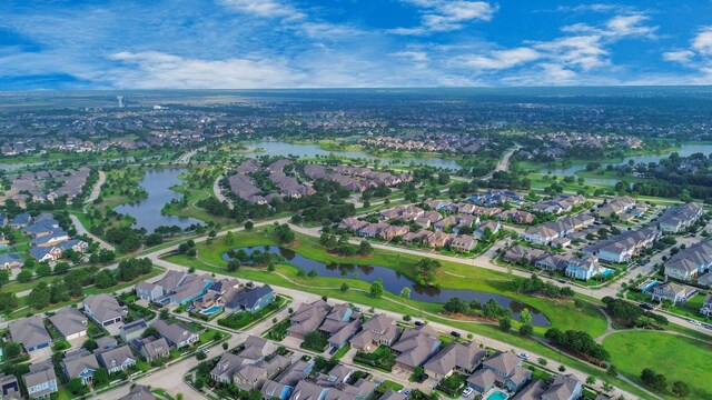 aerial view of property's location with nearby suburban area and a large body of water