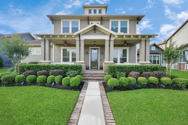 view of front facade with ceiling fan, a porch, and a front yard