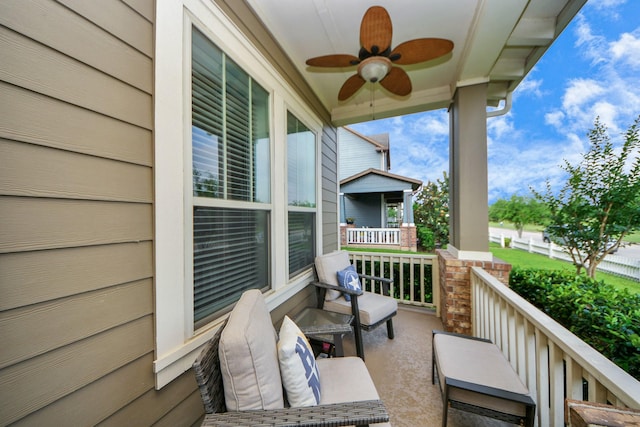 balcony with a porch and ceiling fan