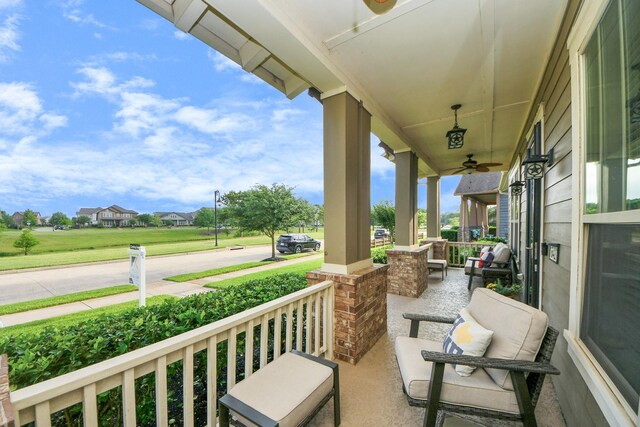 balcony featuring a porch and ceiling fan