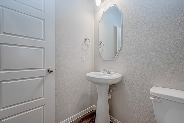 10103 Gold Finch Run, Magnolia, TX 77354 - bathroom featuring a sink, a textured wall, and toilet