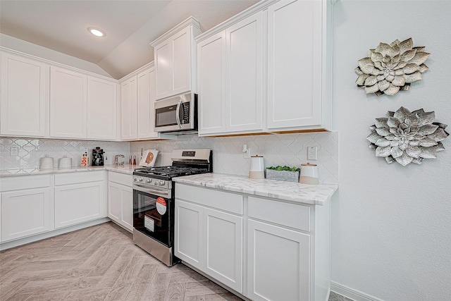 26234 Cooperstown Way, Splendora, TX 77372 - kitchen featuring white cabinets, appliances with stainless steel finishes, light stone counters, and tasteful backsplash