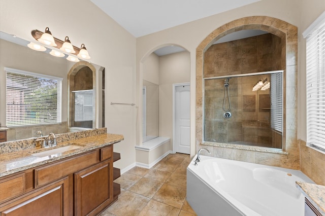 full bath with vanity, tile patterned flooring, a garden tub, and a shower stall
