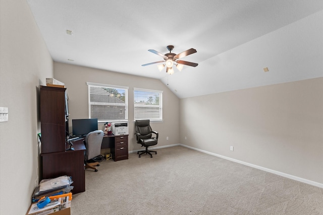 carpeted home office featuring ceiling fan, vaulted ceiling, and baseboards