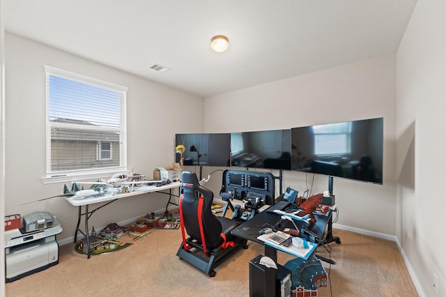 carpeted office space with baseboards and visible vents
