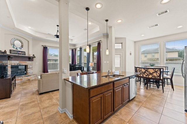 kitchen with stainless steel appliances, a ceiling fan, light tile patterned floors, and a sink