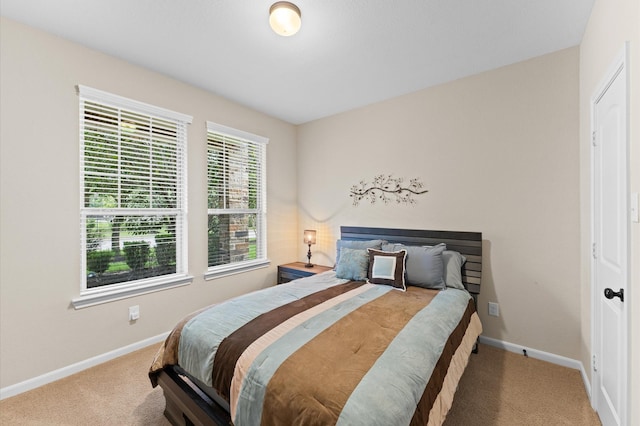 carpeted bedroom with baseboards