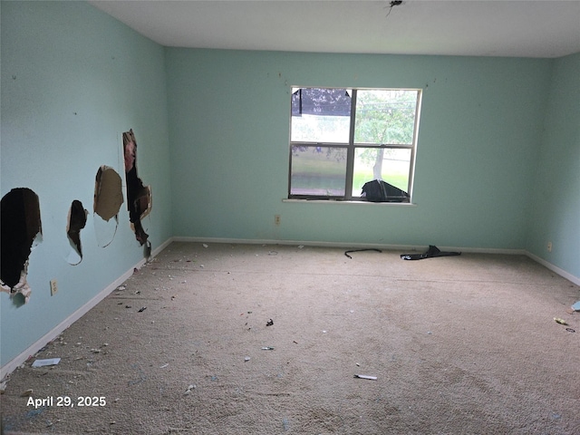 spare room with carpet flooring and baseboards