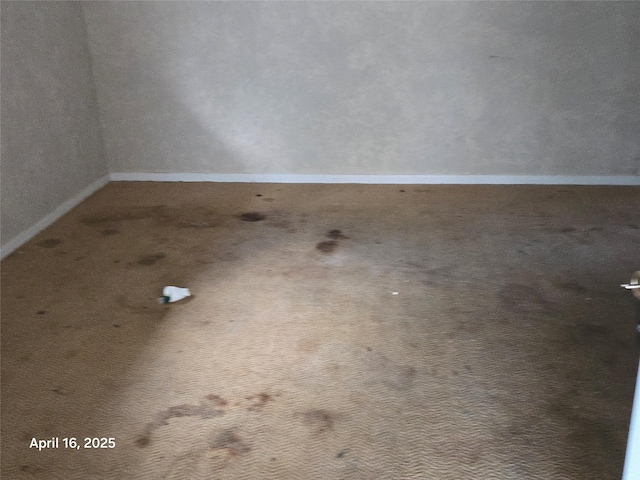 carpeted spare room with baseboards