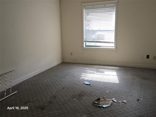 carpeted spare room with baseboards
