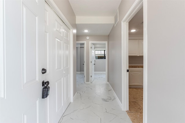 12928 John Reynolds Rd, Galveston, TX 77554 - hallway featuring marble finish floor, visible vents, baseboards, and recessed lighting
