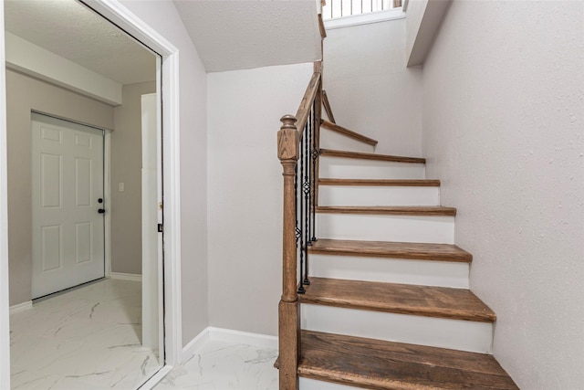 12928 John Reynolds Rd, Galveston, TX 77554 - stairs with baseboards and marble finish floor