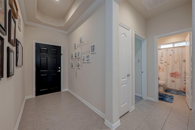 entryway featuring baseboards, light tile patterned flooring, and visible vents
