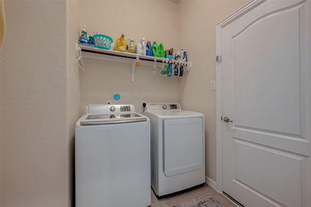 washroom with laundry area, light tile patterned floors, and washing machine and clothes dryer