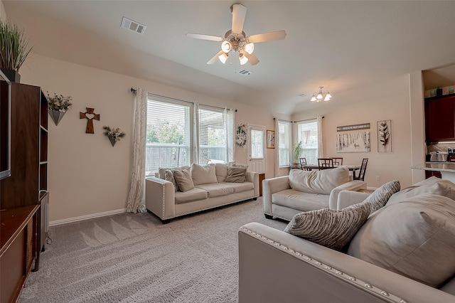living room featuring visible vents, a ceiling fan, baseboards, and light colored carpet